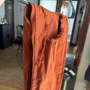 Orange ripped jeans